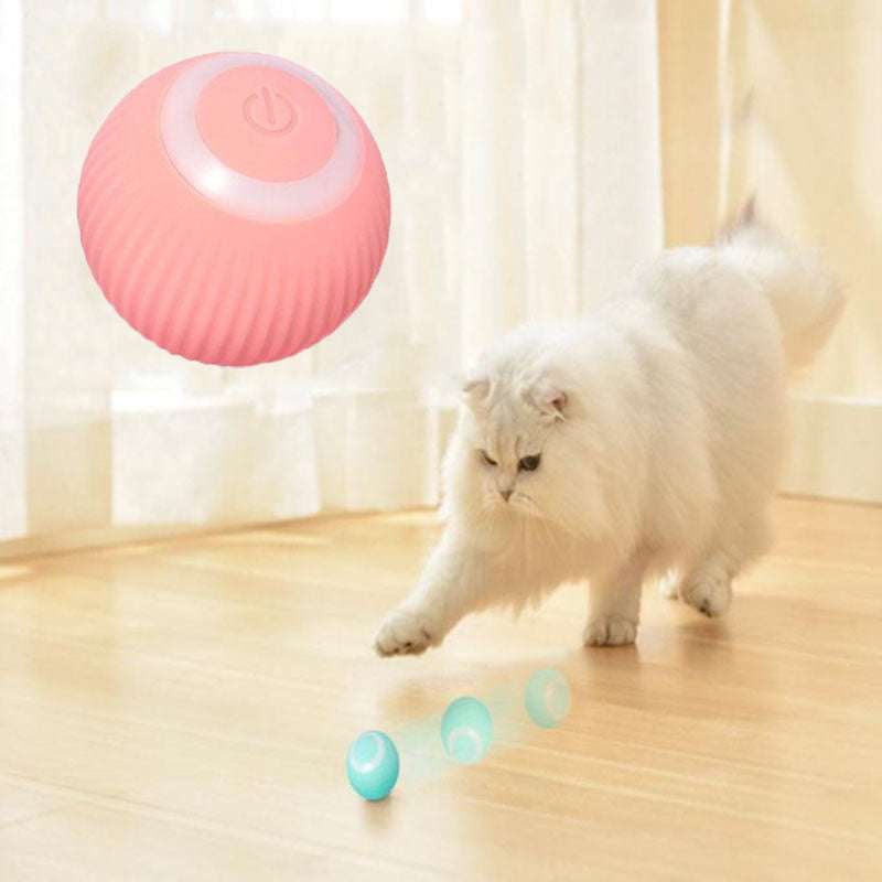 Electric Interactive Cat Ball in coral pink ribbed silicone, with a raised circular power button on top.