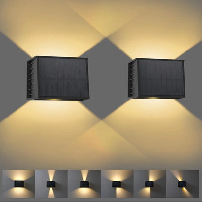 Two solar wall lights emitting a warm glow on a gray background.