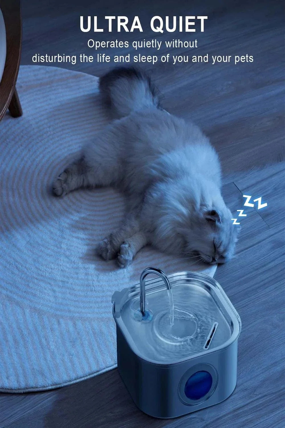 Auto Cat Fountain in a stainless steel reservoir with blue water window and arched spout, beside a sleeping cat