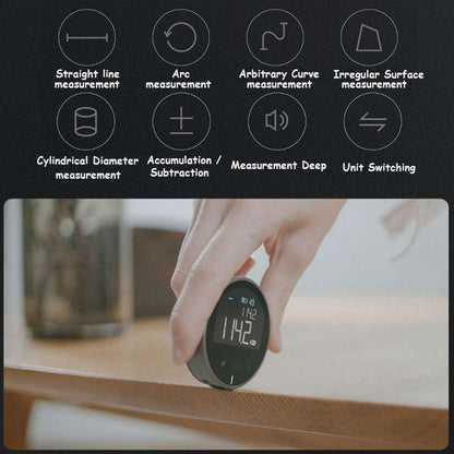 Digital Laser Tape Measure in black and grey, with a compact rounded body and illuminated digital display held above a surface