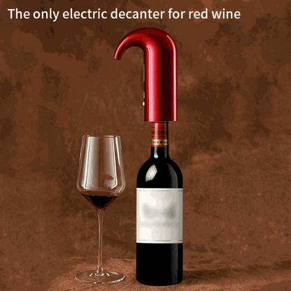 Electric Wine Pump with a glossy red curved spout fitted to a dark wine bottle, beside a glass of red wine