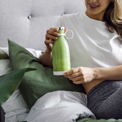 Portable USB Blender Bottle in pale green with a white lid and base, featuring a compact rounded travel-cup shape