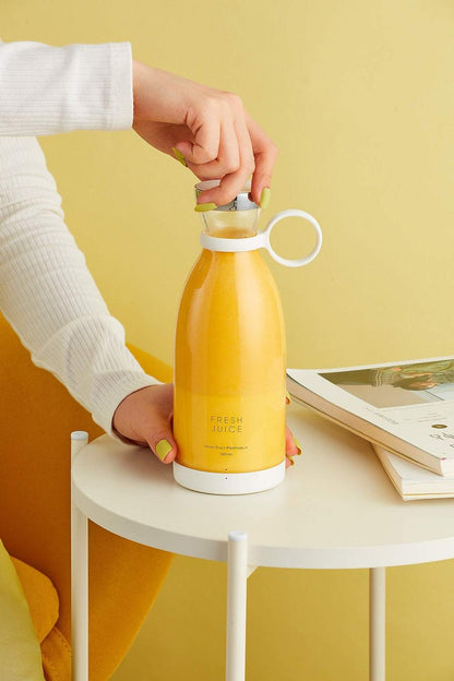 Portable USB Blender Bottle in a yellow-orange finish, with a white lid, carry handle and matching base