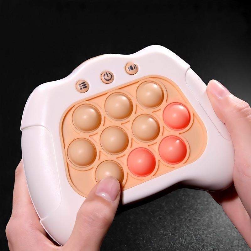 Push Popper Fidget Toy with a white plastic game controller frame and peach silicone bubbles, some in coral red, with three buttons