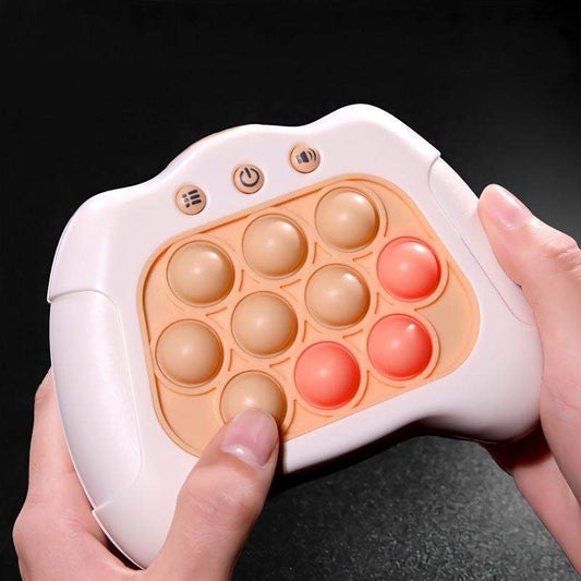 Push Popper Fidget Toy with a white plastic game controller frame and peach silicone bubbles, some in coral red, with three buttons