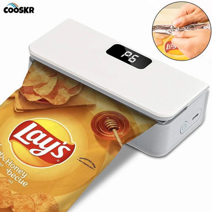 Rechargeable Mini Bag Sealer in white ABS plastic, with a black LED display and rounded rectangular shape, sealing a snack bag.