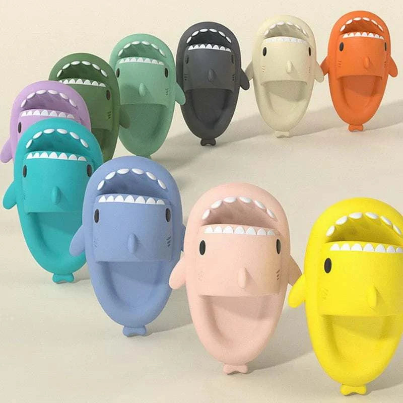 Shark Slides are smooth rubber shark-shaped slides in bright assorted colours, with cartoon eyes and white teeth across the mouth.