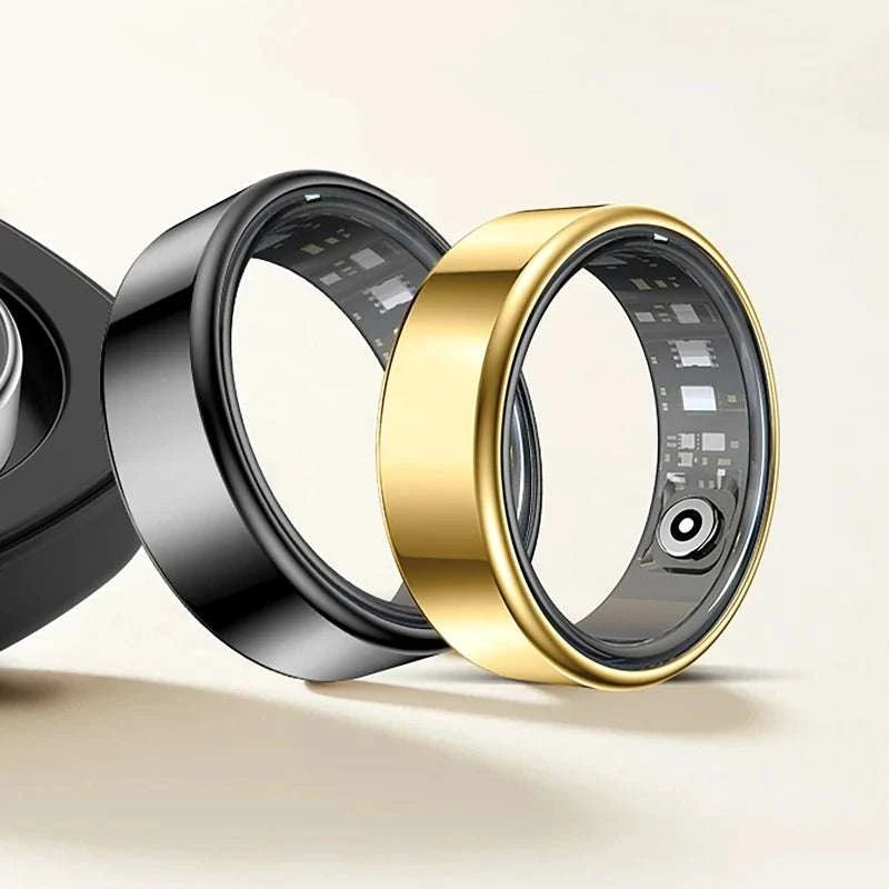 Smart Fitness Ring in polished gold-tone metal, with a smooth wide band and visible inner sensors; black ring also shown.