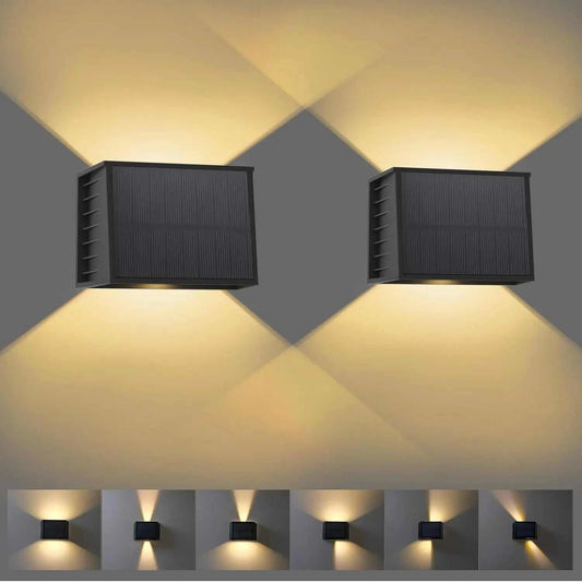 Solar Fence & Wall Light in a black rectangular housing with a ribbed solar panel and dual up-and-down beams of warm light.