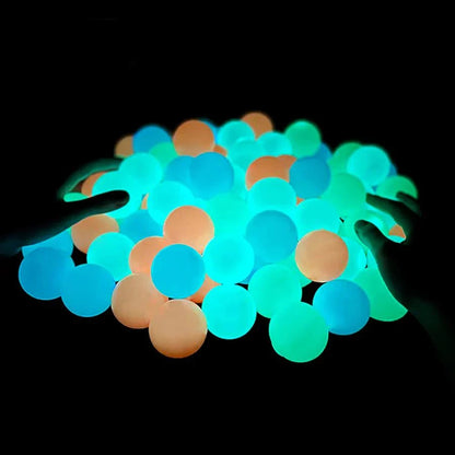 Sticky Glow Balls are smooth, round gel toys in glowing turquoise, blue, green and peach hues, shown in a loose cluster.